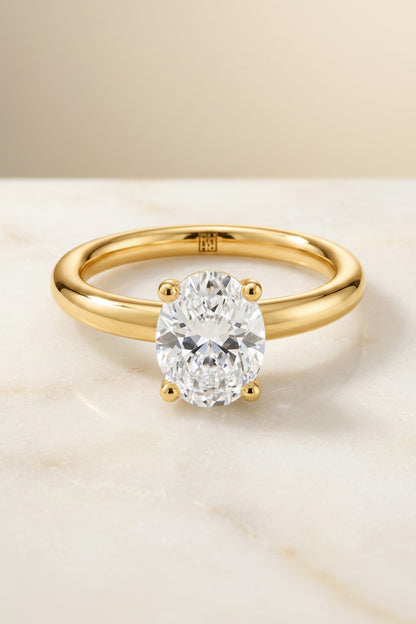 The Tori Select Rounded Comfort Fit Solitaire Oval Lab Diamond Engagement Ring in 18K Yellow Gold, shown on hand, angled | RockHer