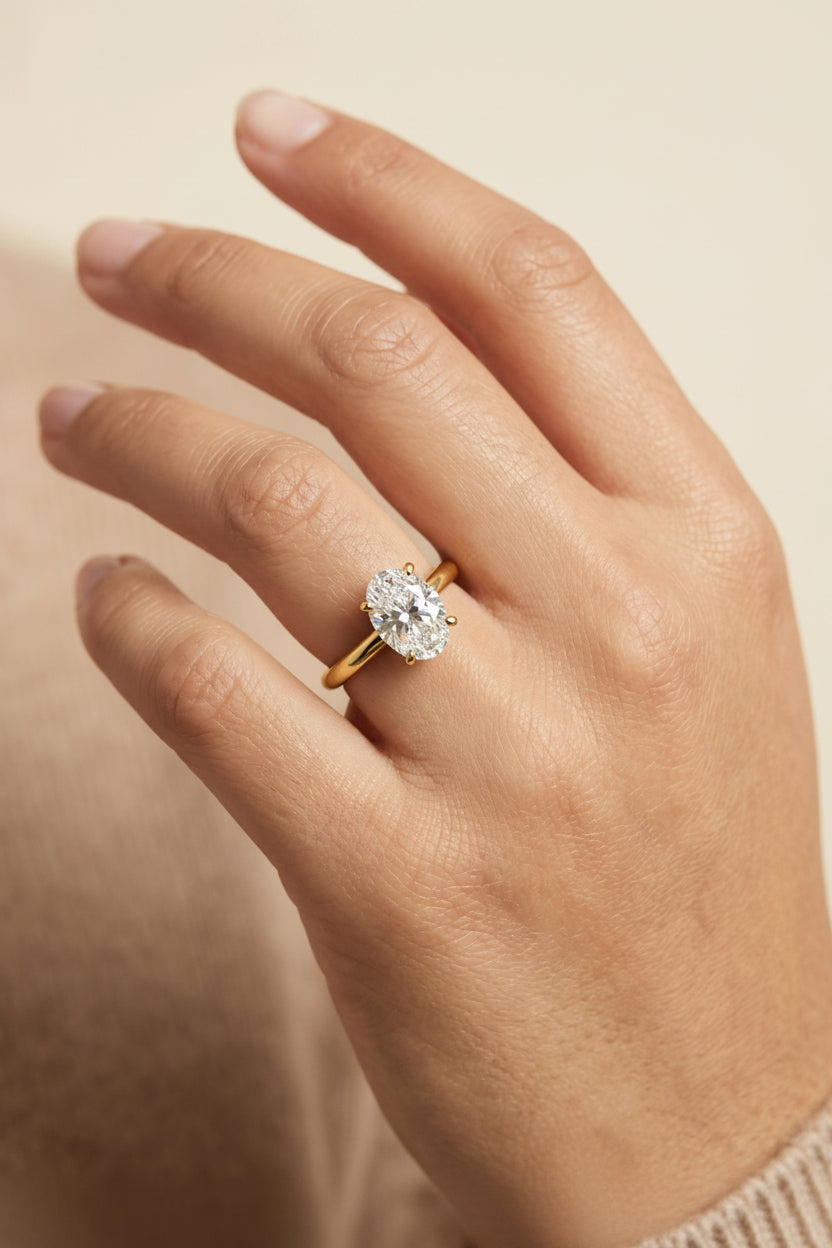 The Tori Select Rounded Comfort Fit Solitaire Oval Lab Diamond Engagement Ring in 18K Yellow Gold, shown on hand | RockHer
