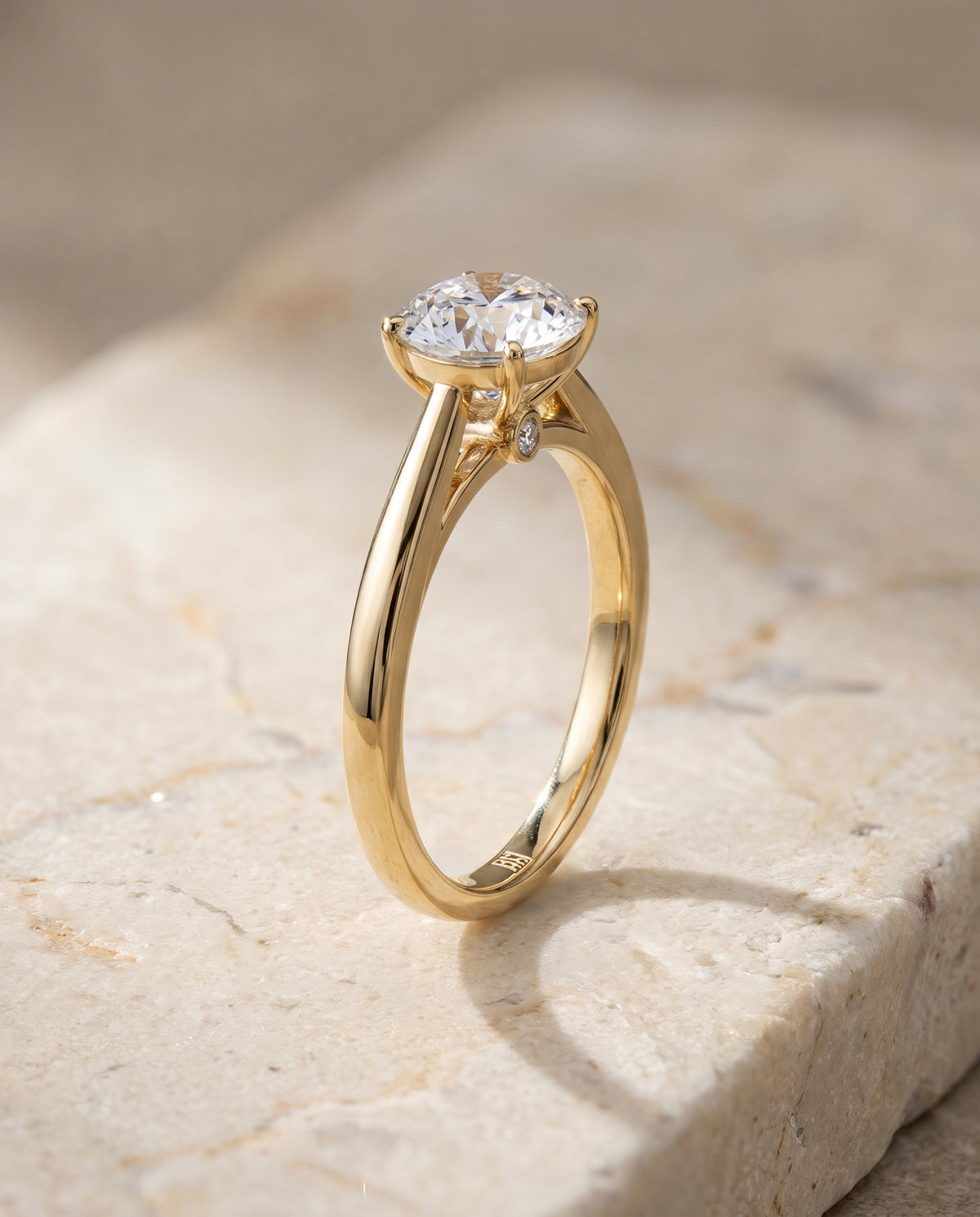 The Valerie Comfort Fit Secret Stone Solitaire Round Engagement Ring Setting in 18K Yellow Gold