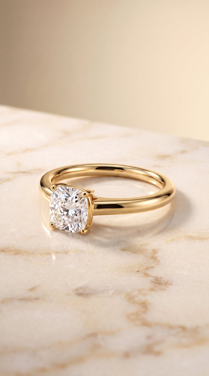 Viola Select Solitaire Cushion Cut Lab Diamond Engagement Ring in 18K Yellow Gold, shown on hand, angled | RockHer