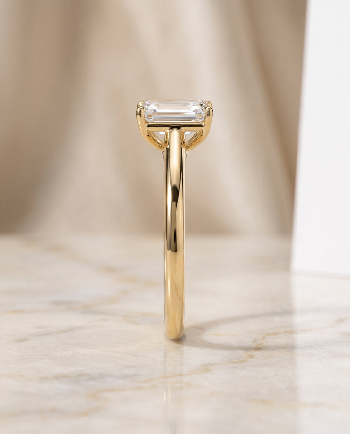 The Viola Contemporary Comfort Fit Flat Shank Solitaire Emerald Cut Engagement Ring Setting in 18K Yellow Gold