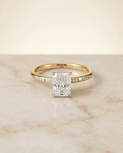 Wanda Select Hidden Halo Pavé Solitaire Radiant Cut Lab Diamond Engagement Ring in 18K Yellow Gold, shown on hand, angled | RockHer