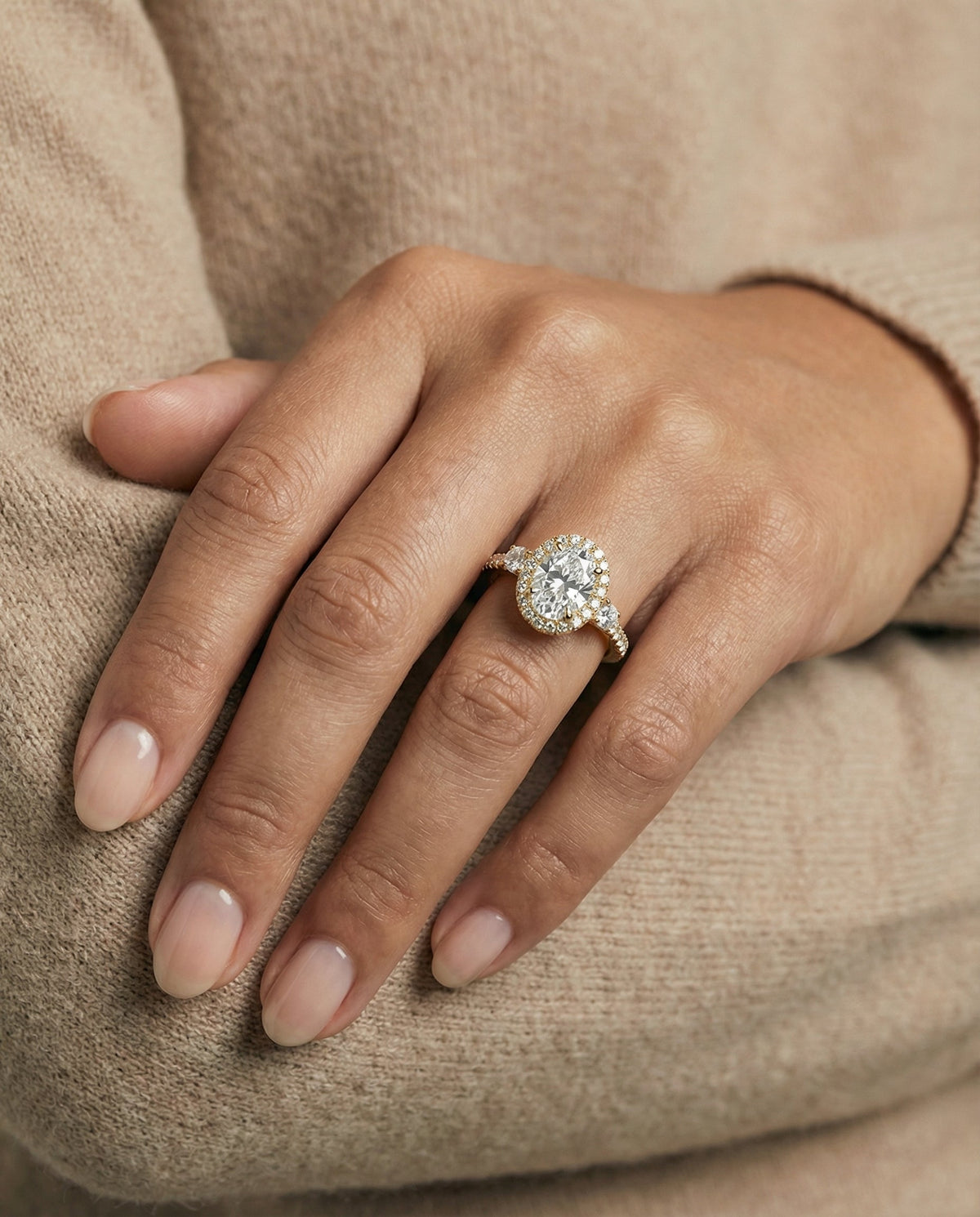 Ivy Select Three Stone Delicate Halo Ov Oval Lab Diamond Engagement Ring in 18K Yellow Gold, shown on hand | RockHer