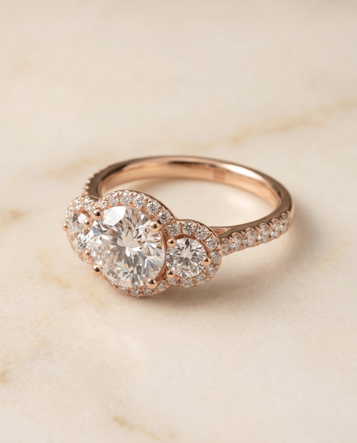 Round Brilliant, Three Stone Halo, in 14K Rose Gold, pave setting – angled view | RockHer