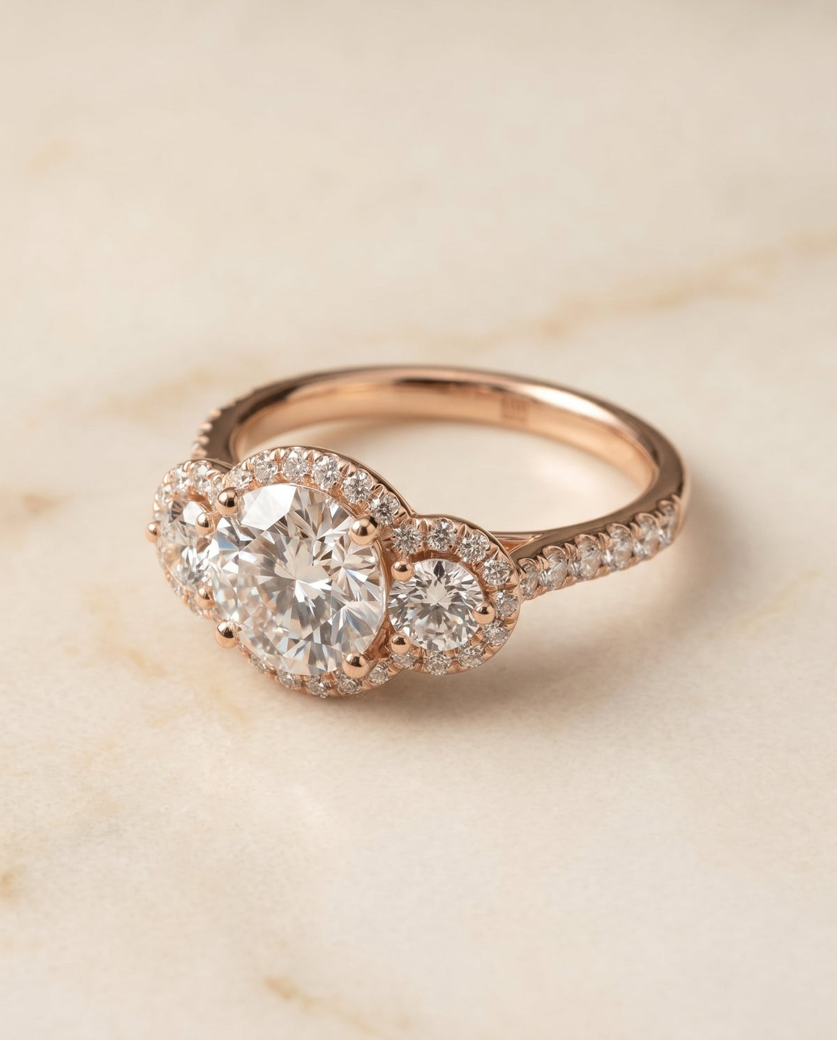 Andrea Select Three Stone Halo Round Lab Diamond Engagement Ring in 14K Rose Gold, alternate angle | RockHer