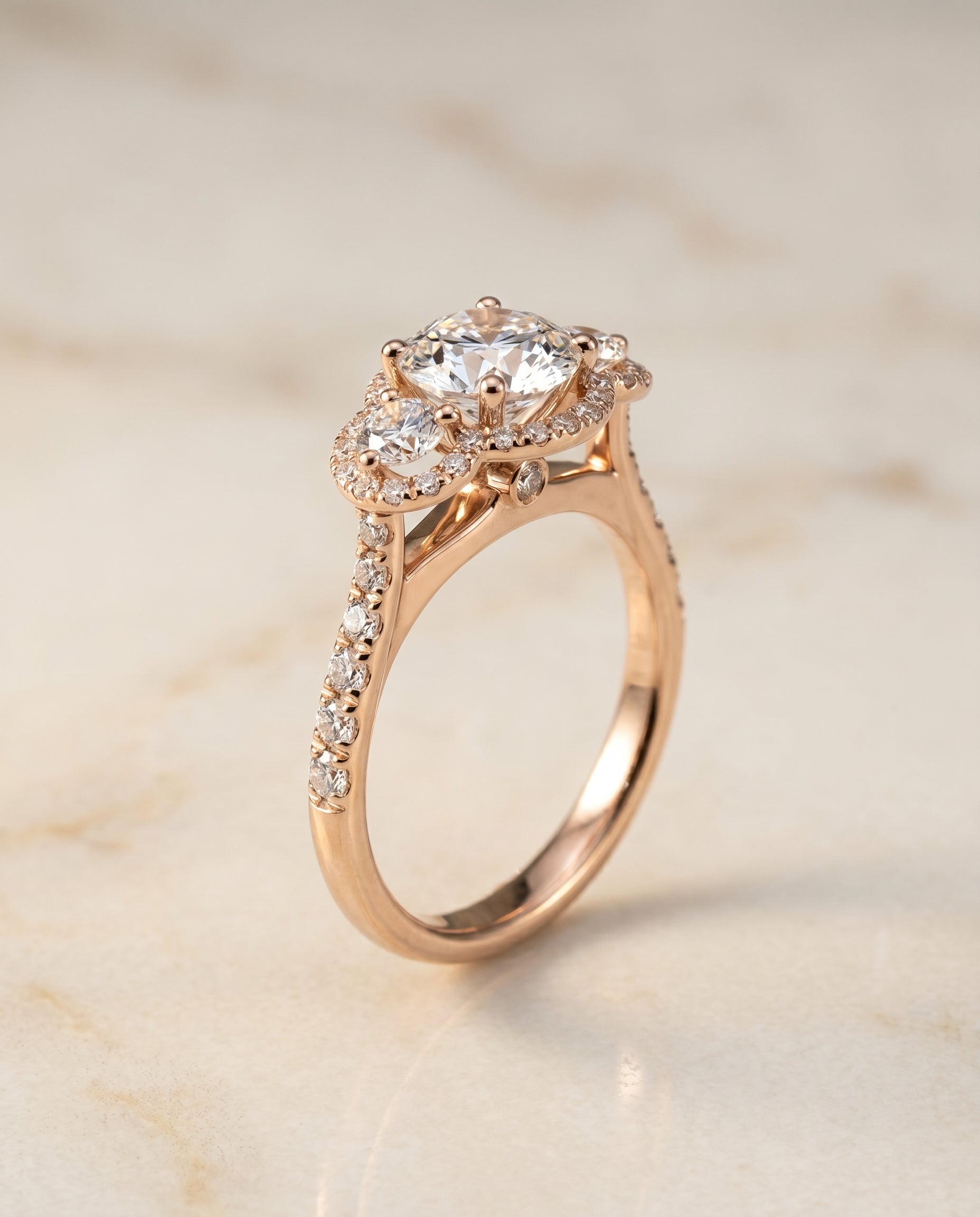 Three Stone Halo styling on The Andrea round engagement ring setting | RockHer