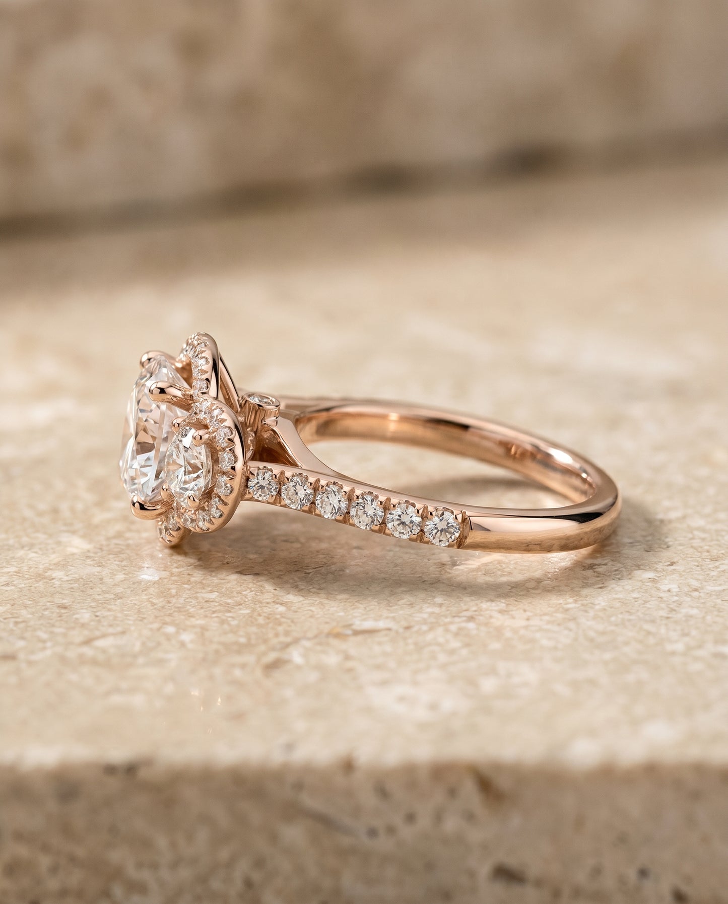 Round Brilliant, Three Stone Halo, in 14K Rose Gold, pave setting – side profile | RockHer