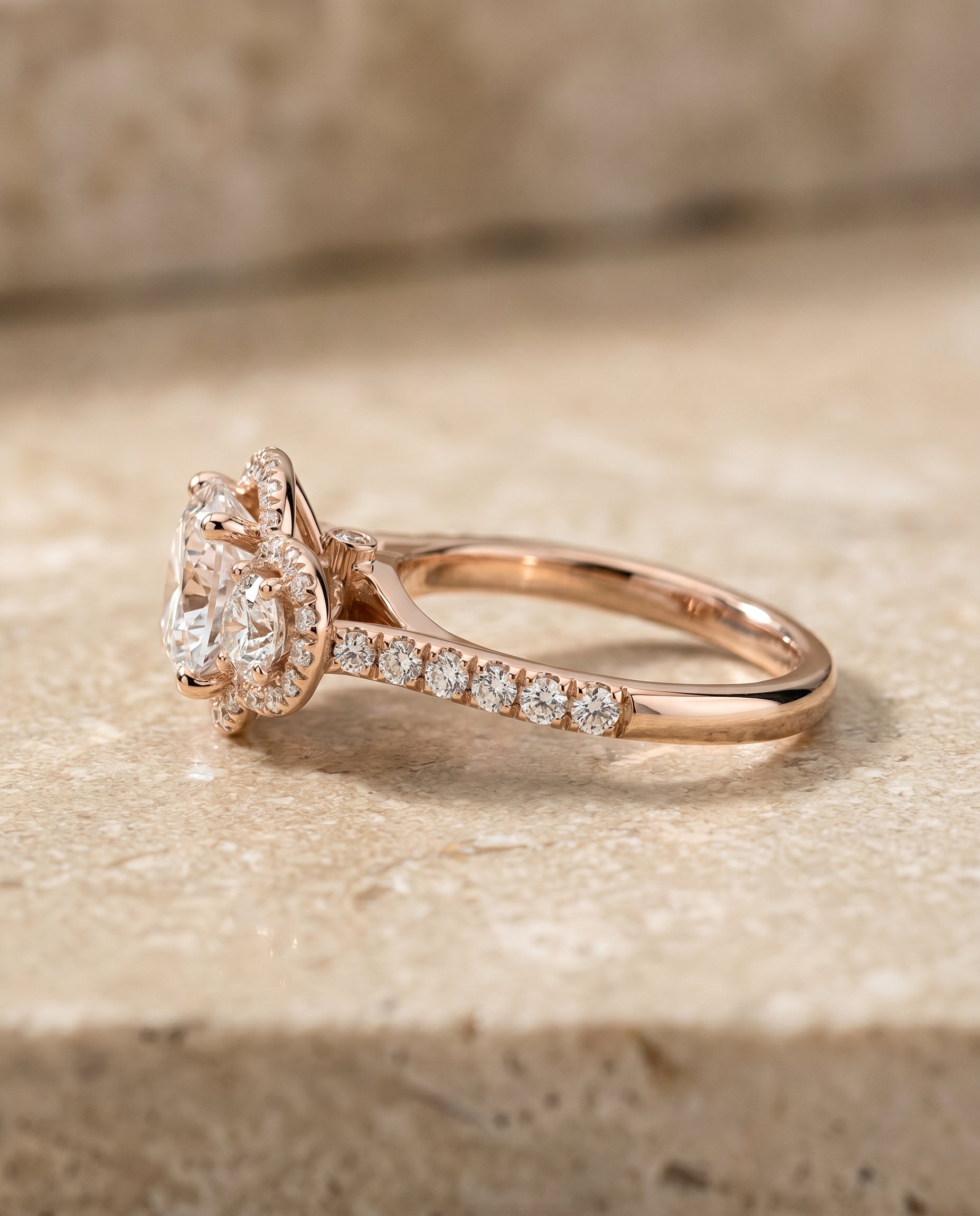 The Andrea three stone halo engagement ring setting, shown in 14K Rose Gold | RockHer
