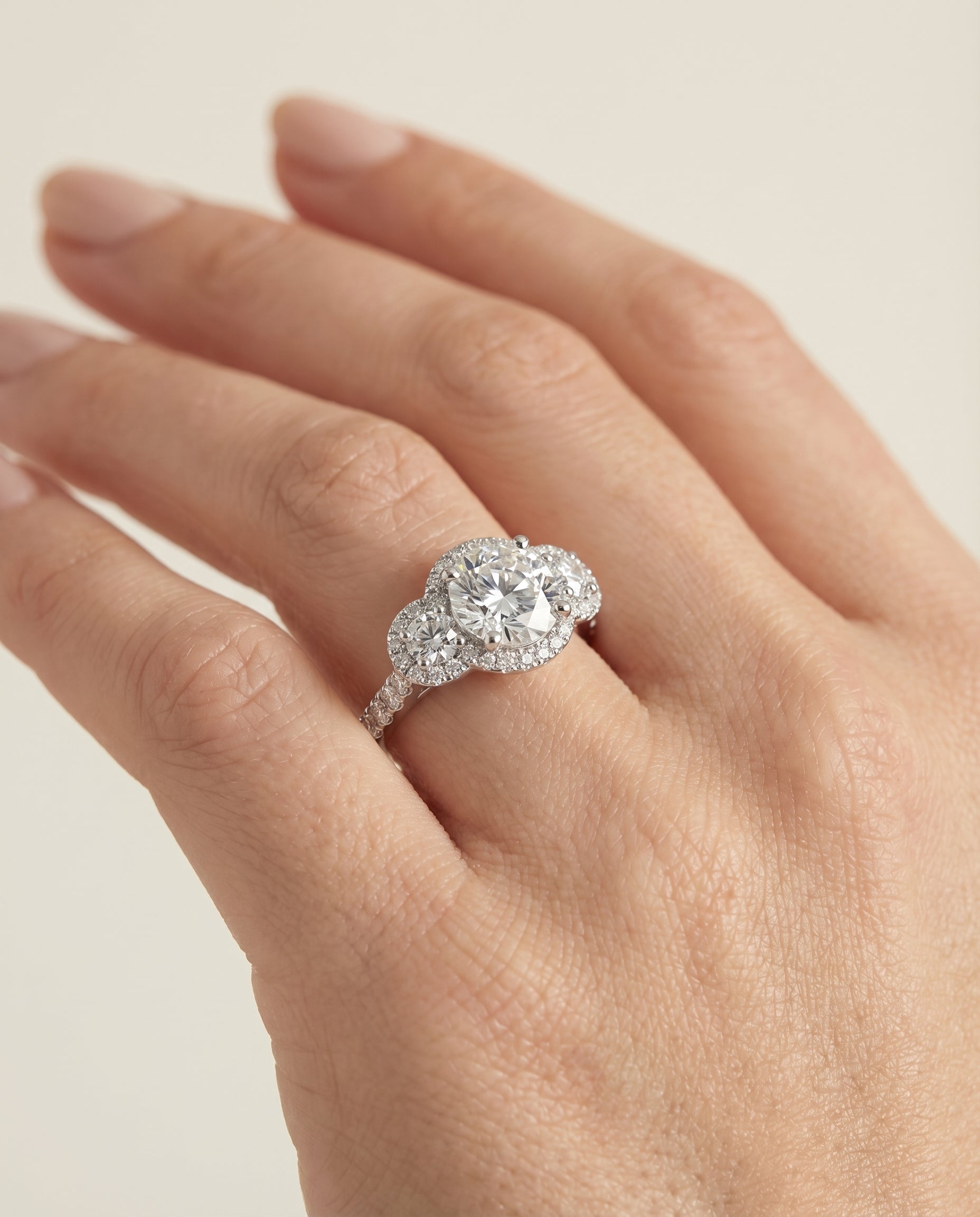 The Andrea engagement ring setting in Platinum, three stone halo design | RockHer