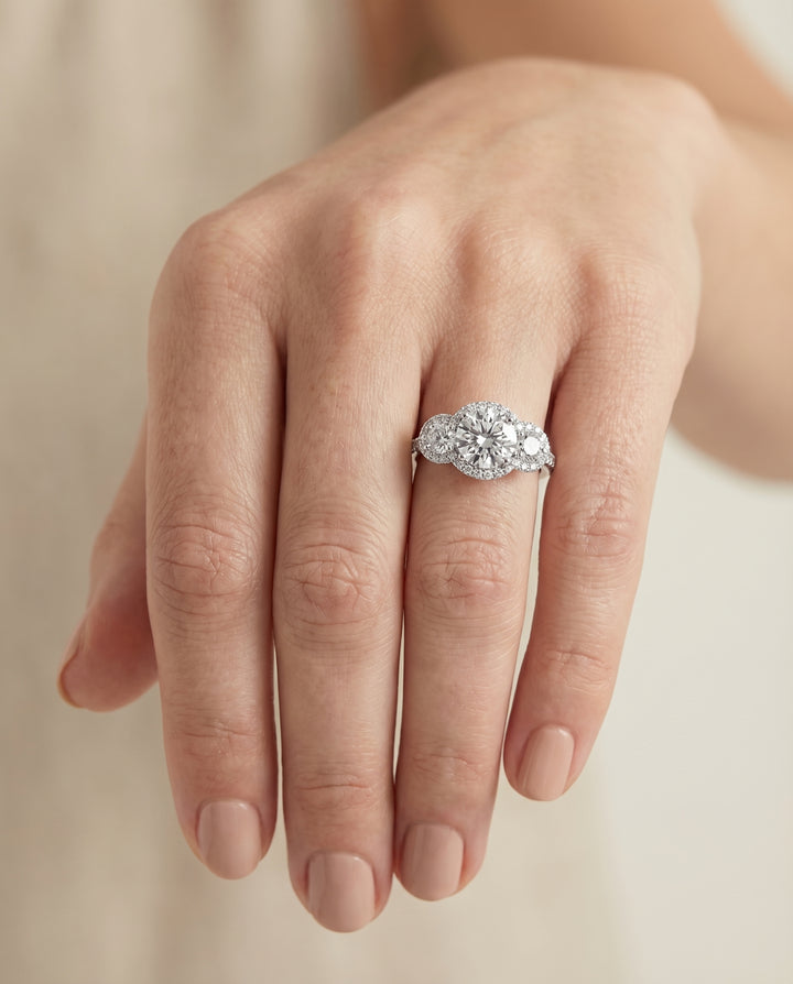 Round Brilliant, Three Stone Halo, in Platinum, pave setting – lifestyle shot | RockHer