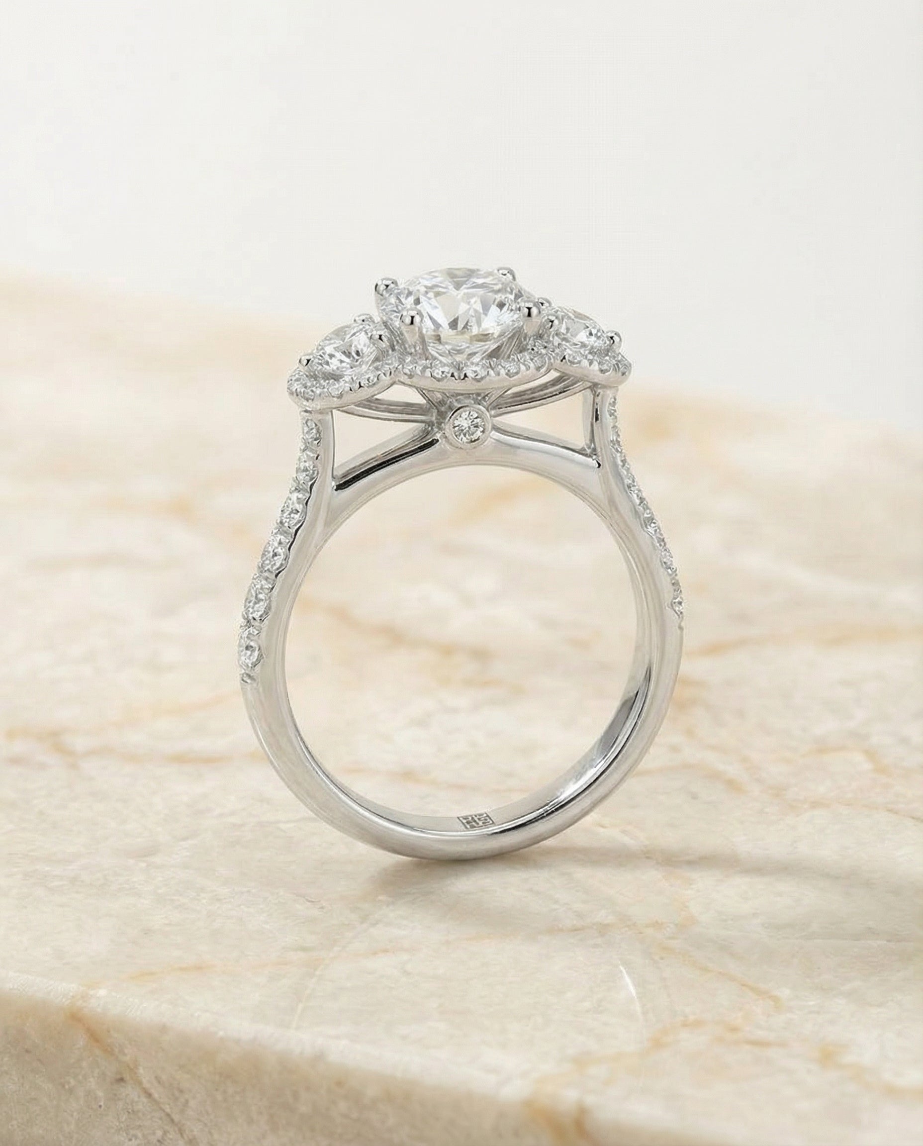 The Andrea three stone halo engagement ring setting, shown in Platinum | RockHer