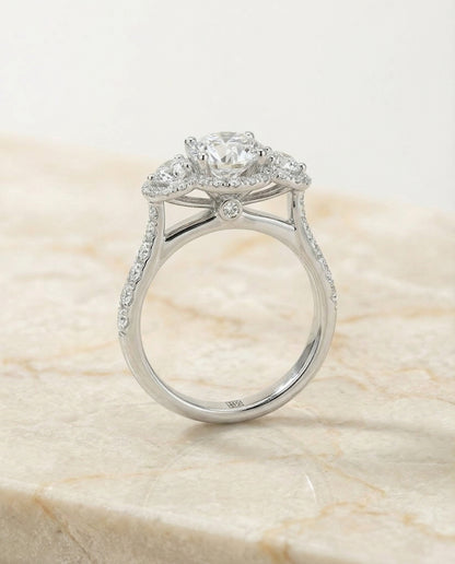 Round Brilliant, Three Stone Halo, in Platinum, pave setting – side profile | RockHer