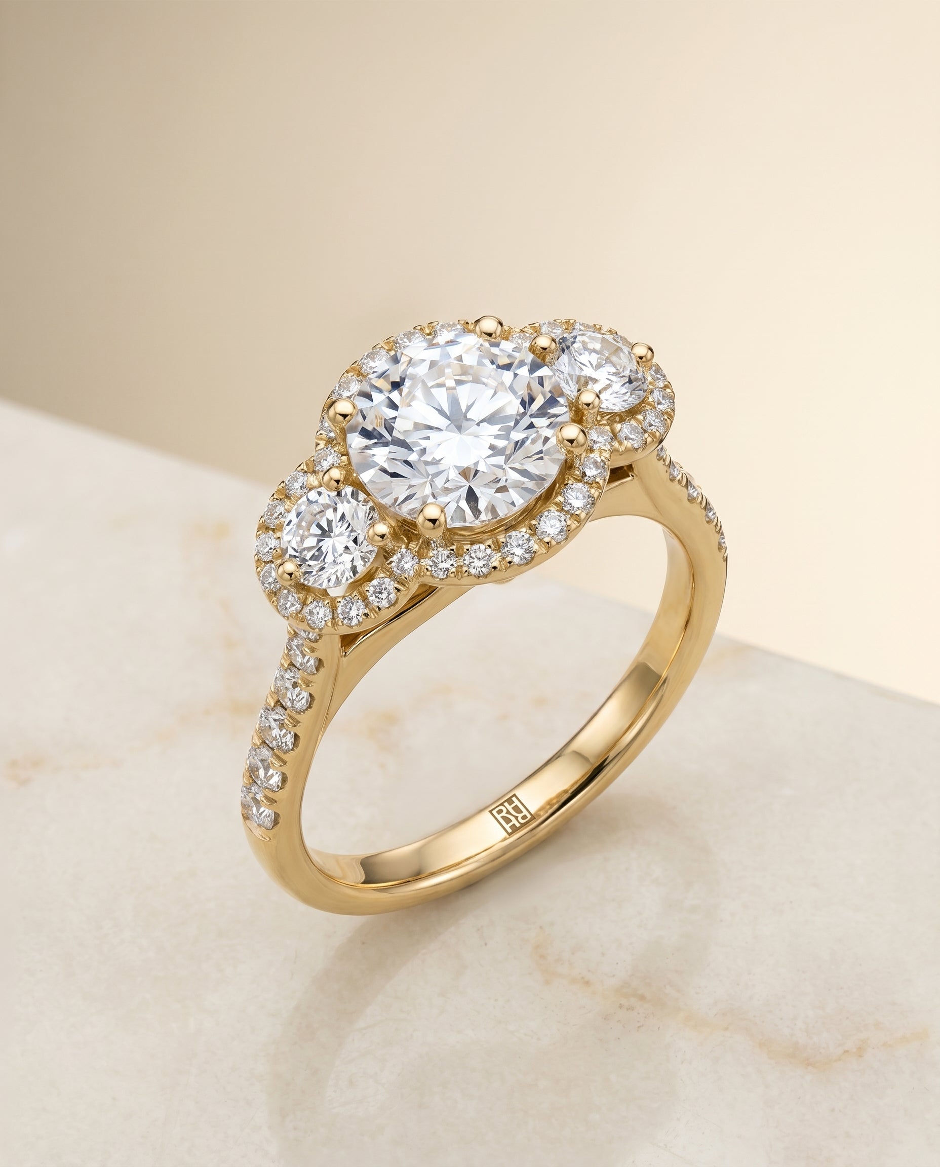 Three Stone Halo styling on The Andrea round engagement ring setting | RockHer