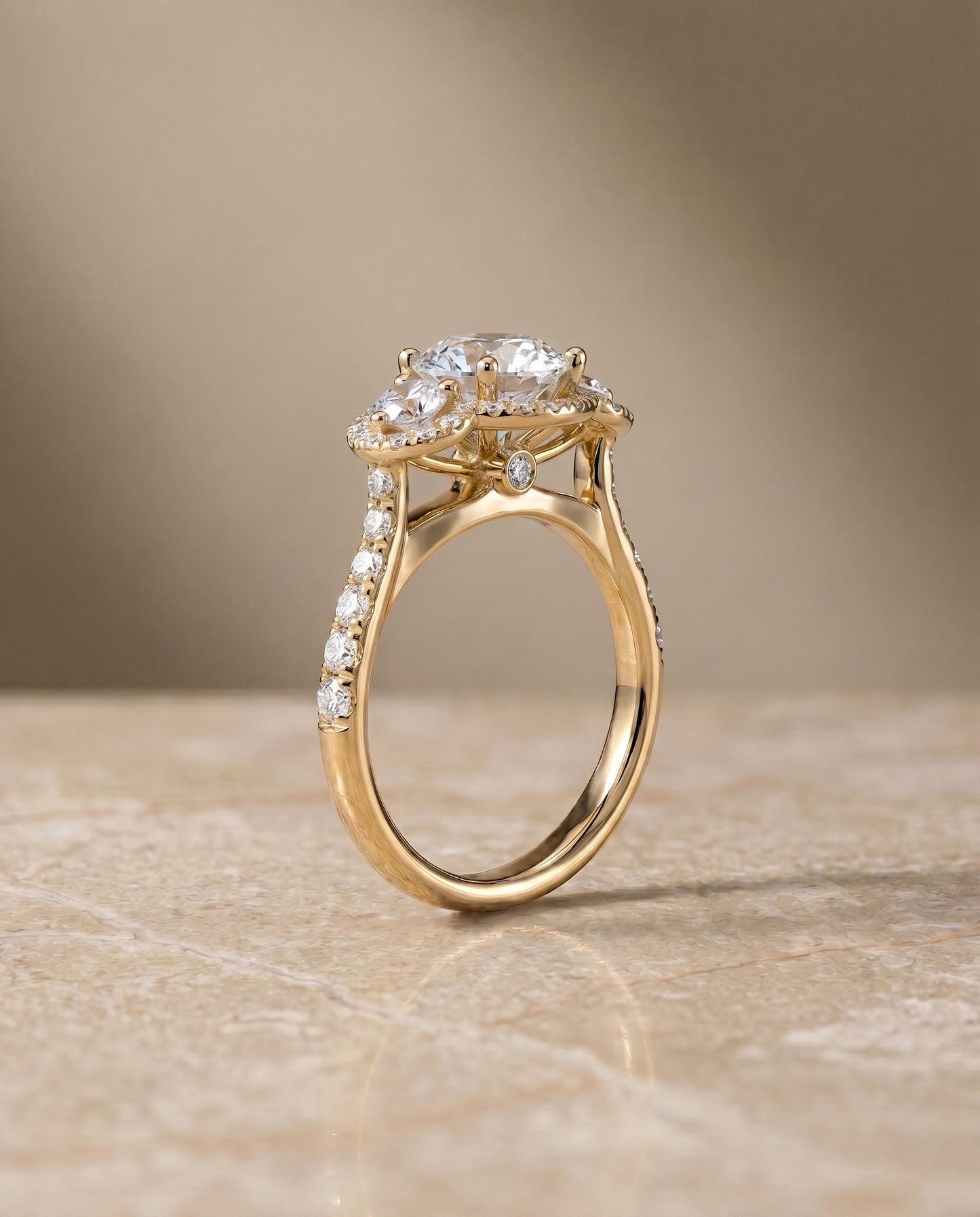 Round Brilliant, Three Stone Halo, in 18K Yellow Gold, pave setting – side profile | RockHer