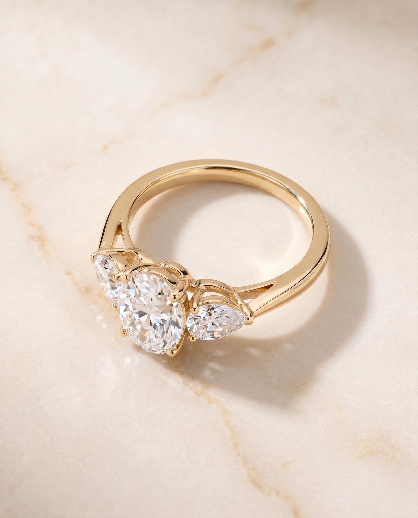 Angelica Select Three Stone Matched Oval Lab Diamond Engagement Ring in 18K Yellow Gold, shown on hand, angled | RockHer