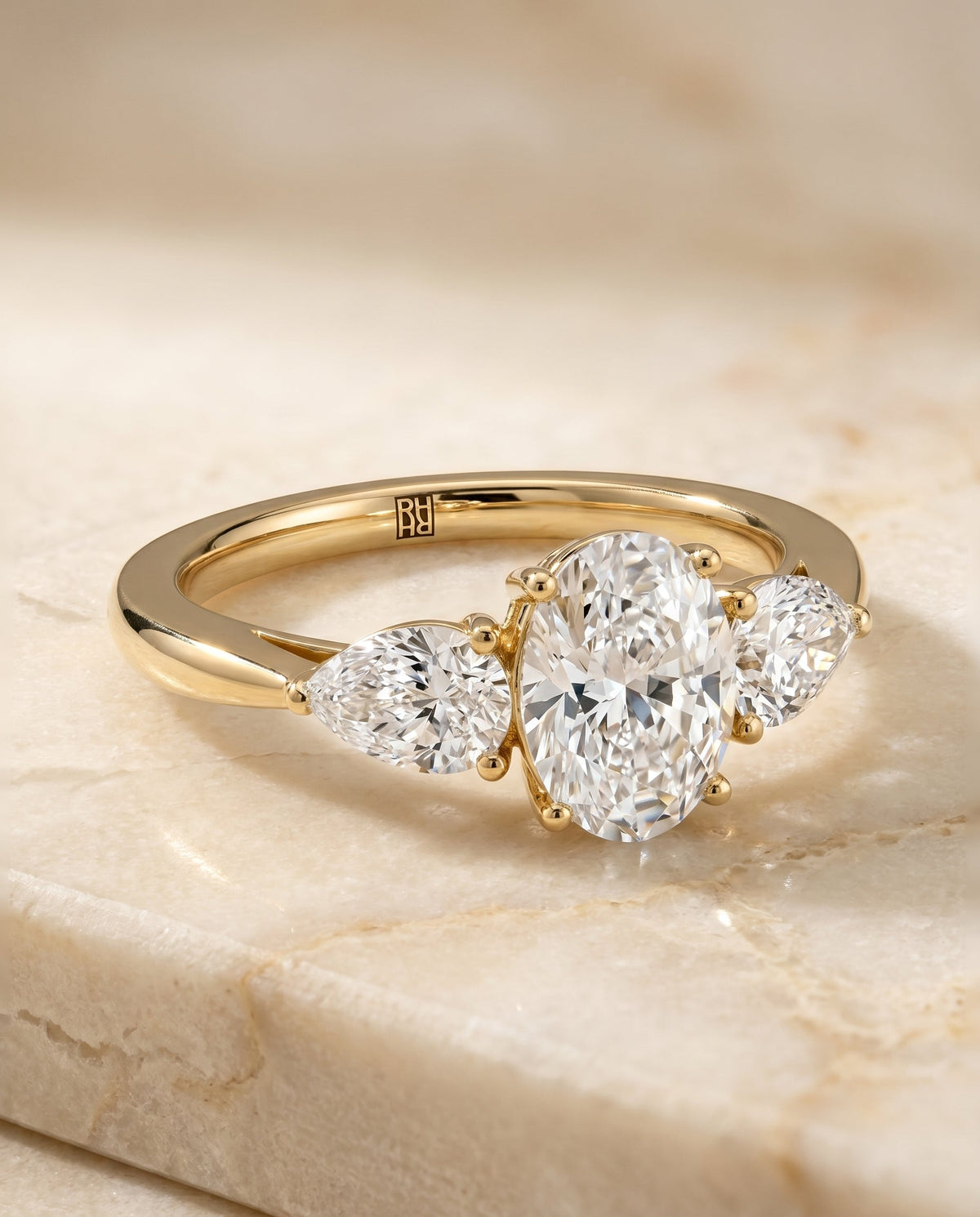 Angelica Select Three Stone Matched Oval Lab Diamond Engagement Ring in 18K Yellow Gold, shown on hand | RockHer