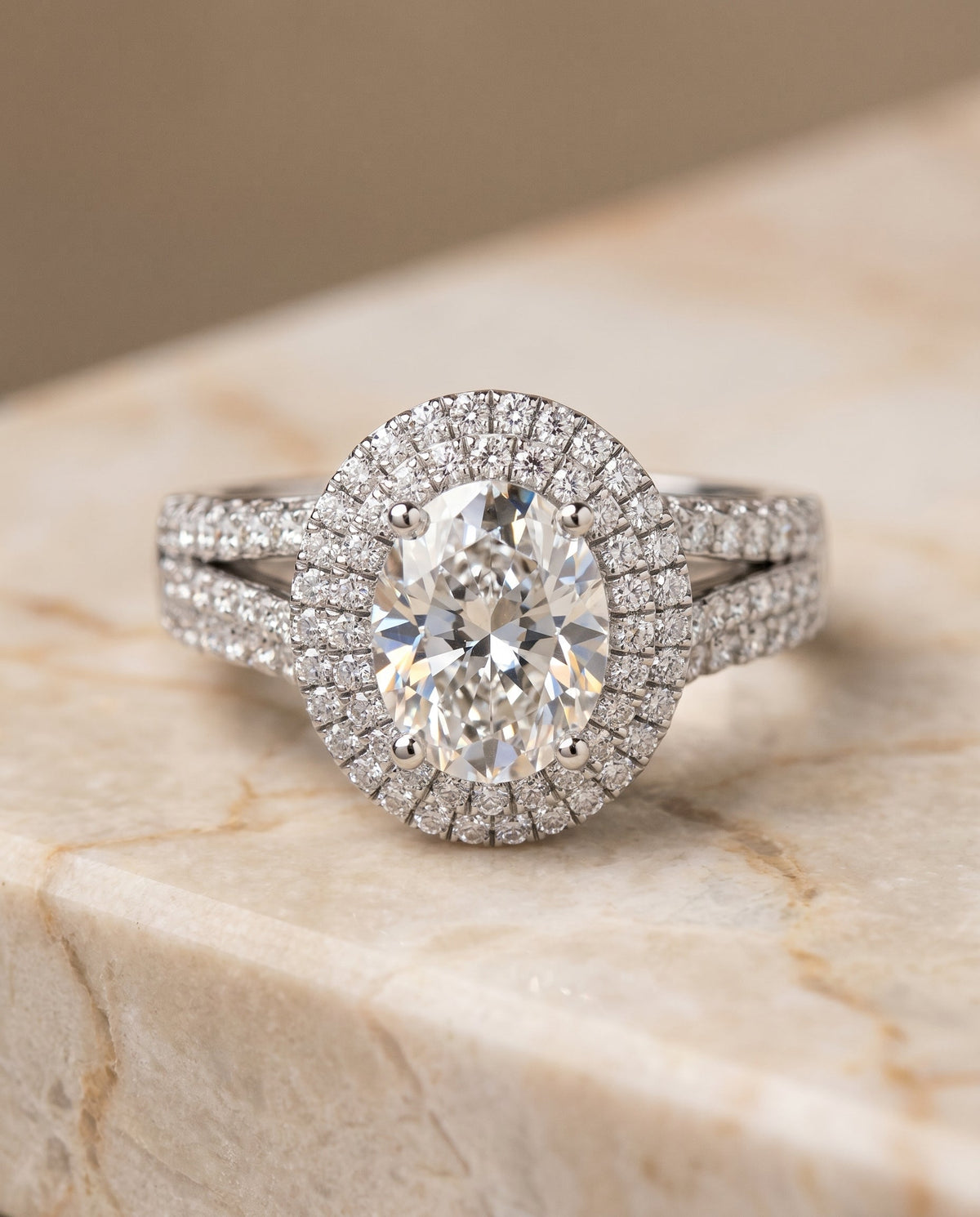 Mariah Select Three Tier Halo Crown Oval Lab Diamond Engagement Ring in Platinum, shown on hand, angled | RockHer