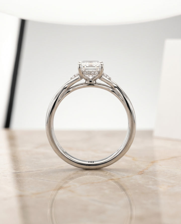 The Dusty Twisted Hidden Halo Solitaire Engagement Ring Setting for Emerald Cut Diamonds in Platinum
