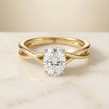 The Grace Twisted Shank Hidden Halo Solitaire Oval Engagement Ring Setting in 18K Yellow Gold