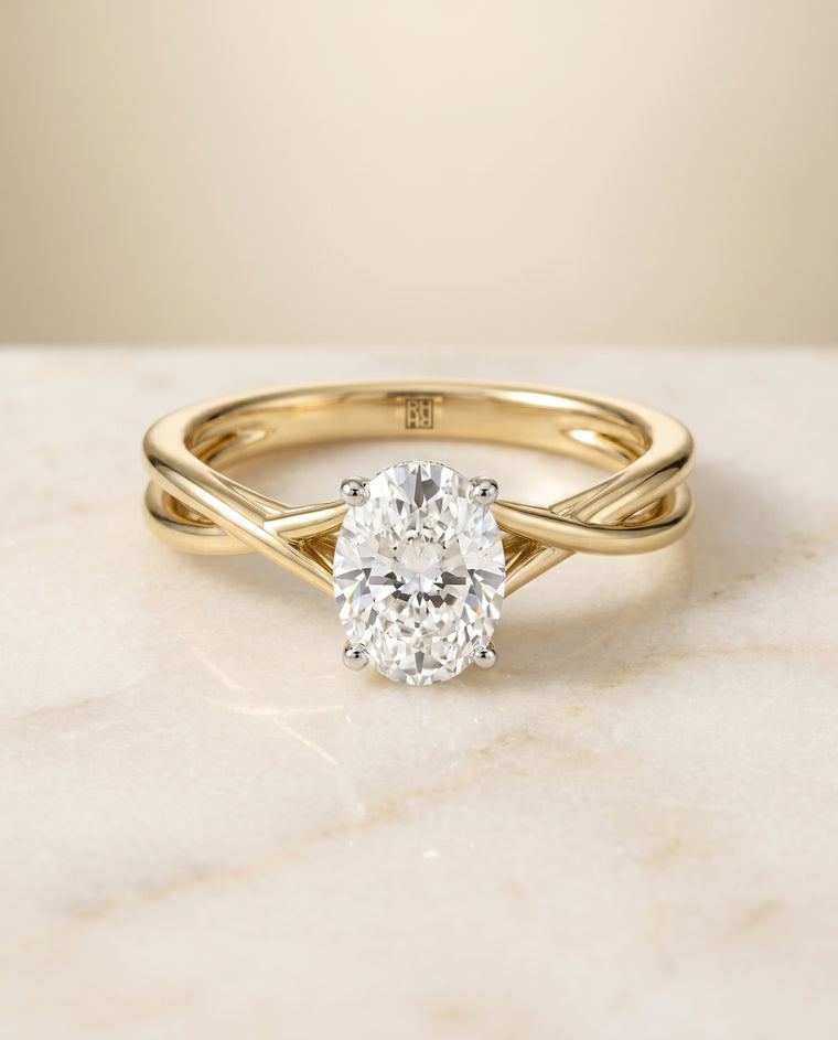 The Grace Twisted Shank Hidden Halo Solitaire Oval Engagement Ring Setting in 18K Yellow Gold