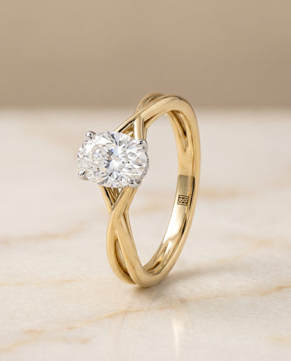 The Grace Twisted Shank Hidden Halo Solitaire Oval Engagement Ring Setting in 18K Yellow Gold