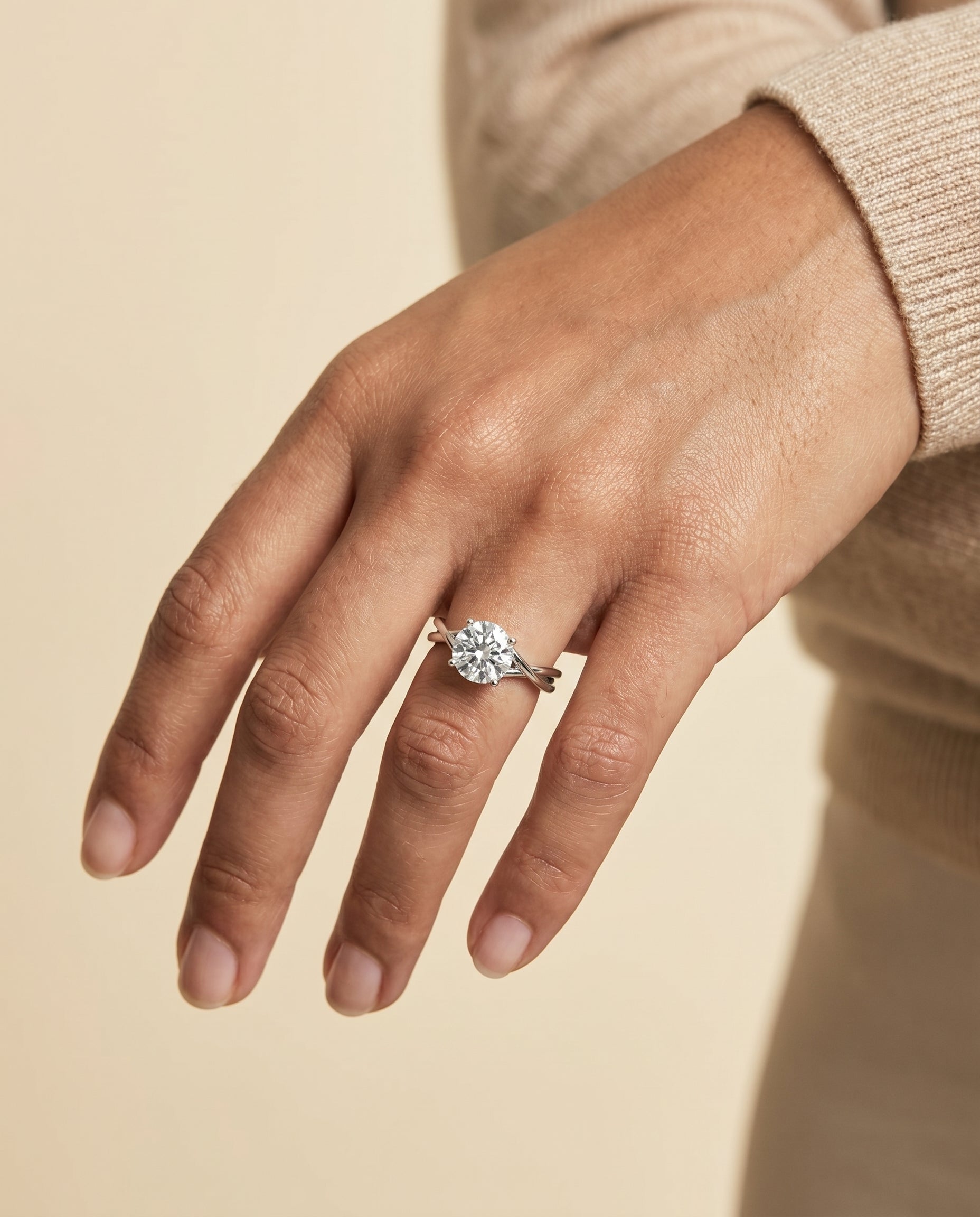 Grace Select Twisted Shank Hidden Halo Solitaire Round Lab Diamond Engagement Ring in 18K White Gold, shown on hand | RockHer