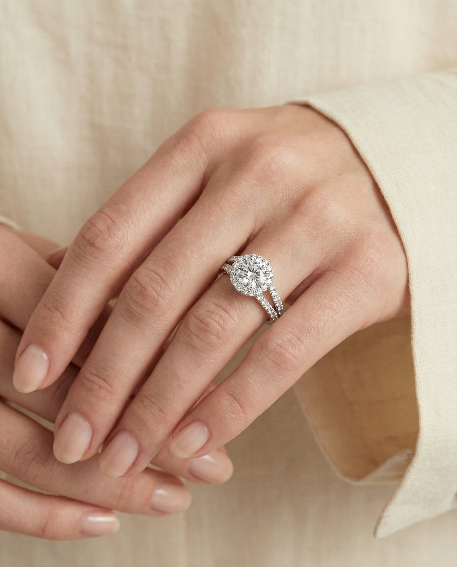 Celine Select Pav Halo Split Shank Round Lab Diamond Engagement Ring in 18K White Gold, shown on hand, angled | RockHer