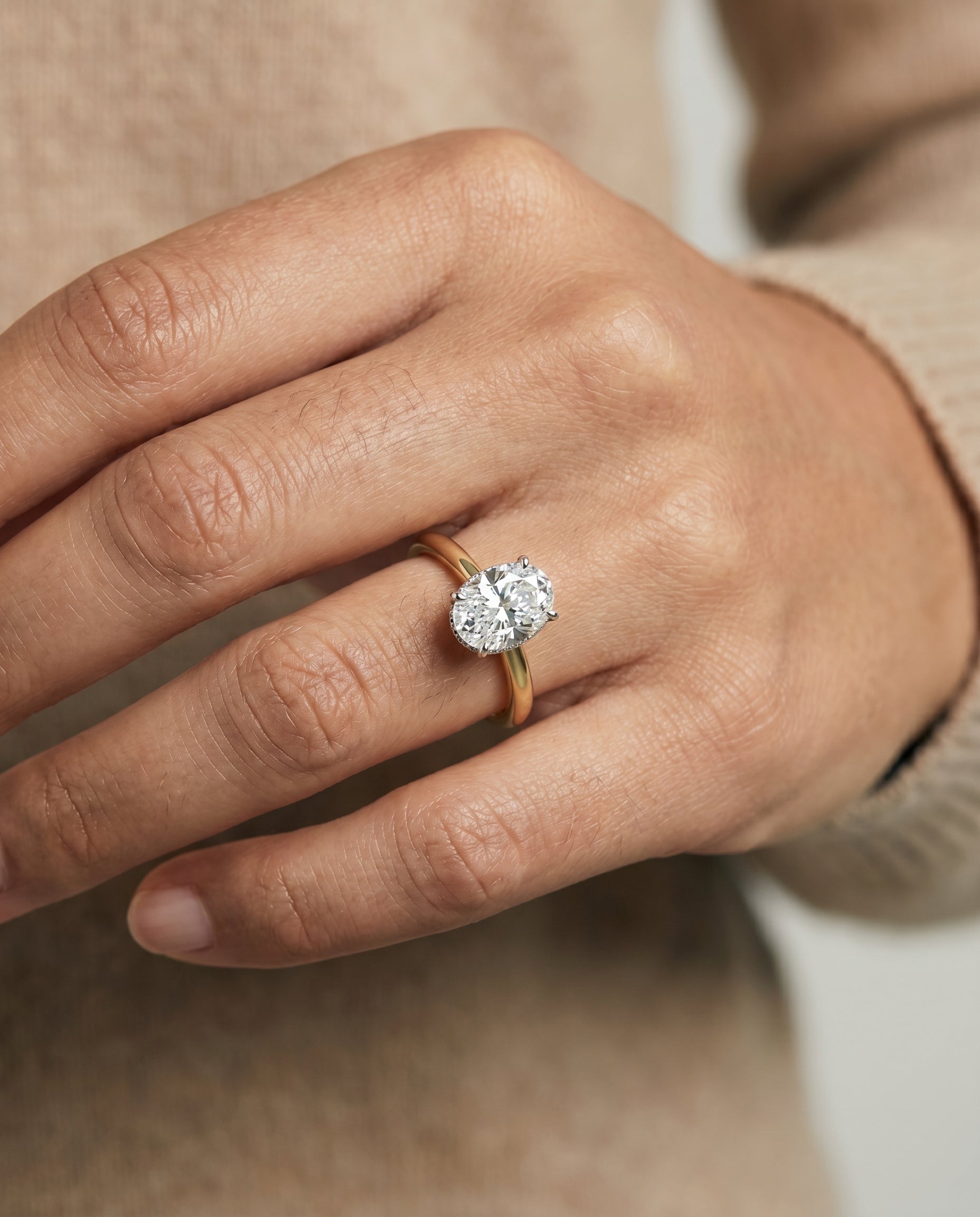 Eartha Select Upper Hidden Halo Solitaire Oval Lab Diamond Engagement Ring in 18K Yellow Gold, shown on hand | RockHer