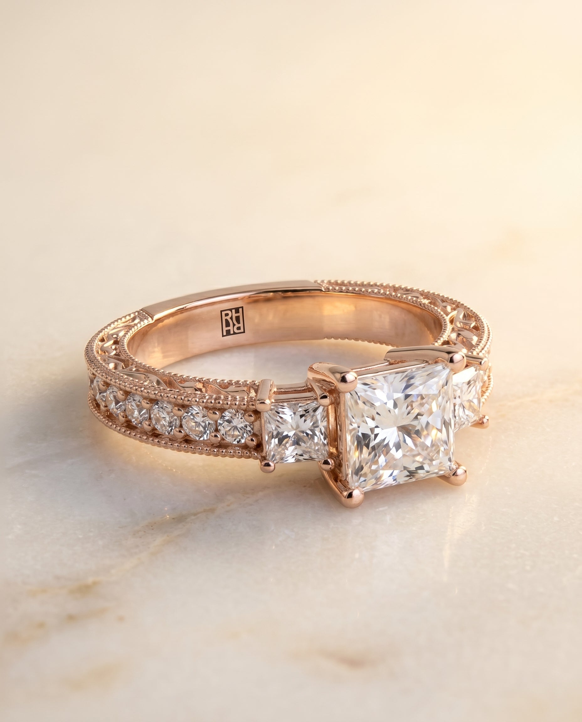 Princess, Vintage Hand-Engraved Three Stone, in 14K Rose Gold, prong setting – angled view | RockHer