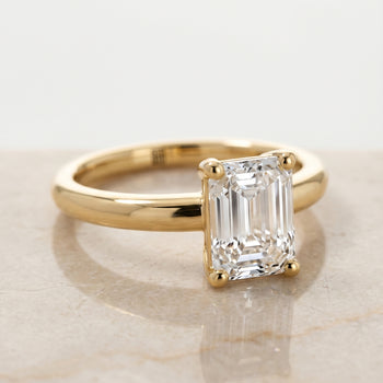 The Tori Rounded Comfort Fit Solitaire Emerald Cut Engagement Ring Setting in 18K Yellow Gold