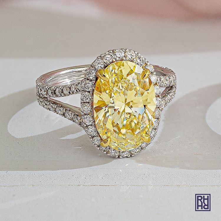 Hands delicately holding a diamond engagement ring, the craft behind every piece