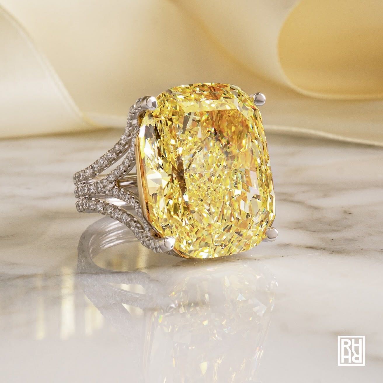 Hands delicately holding a diamond engagement ring, the craft behind every piece