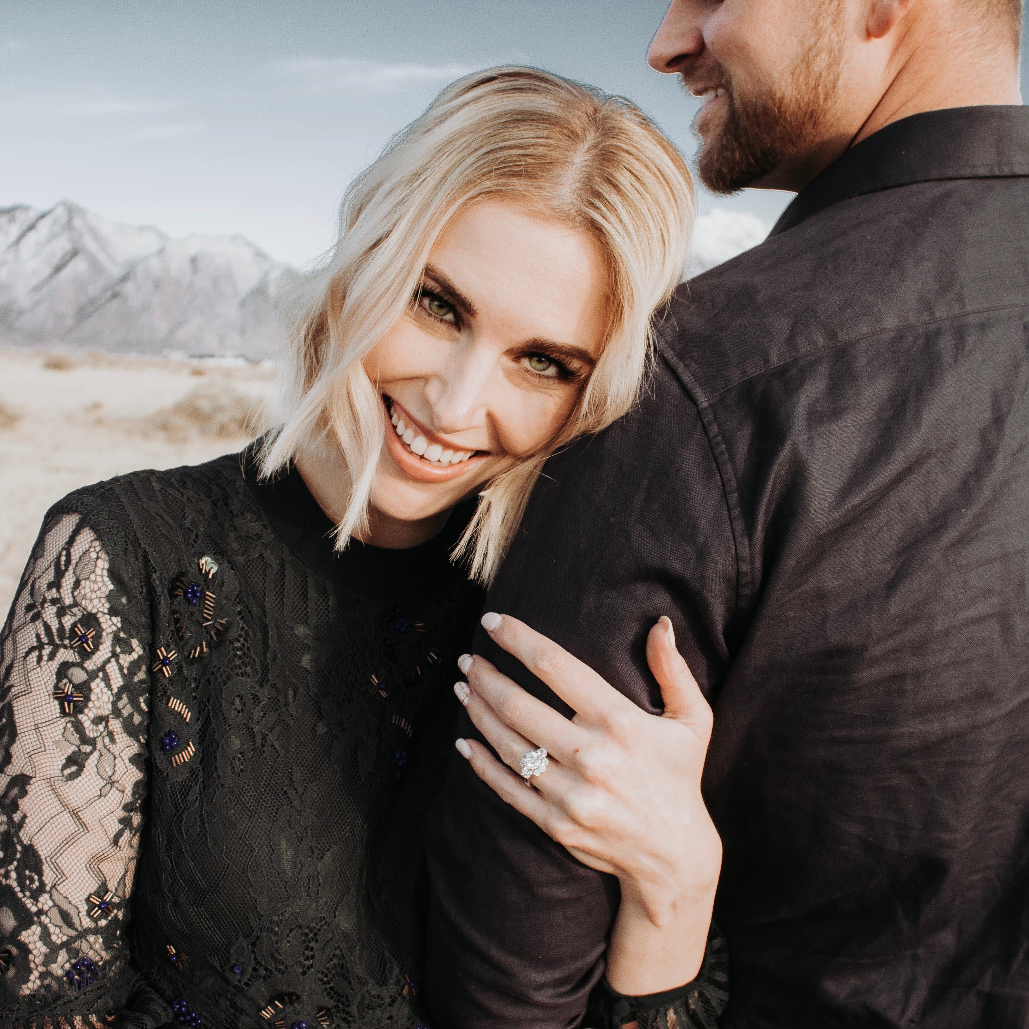 Natural diamond engagement ring worn on hand in soft natural light