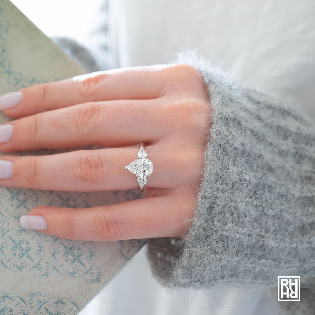 Natural diamond engagement ring worn on hand in soft natural light